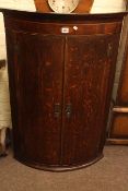 Georgian oak and mahogany bow front two door corner wall cabinet, 103cm high.