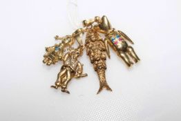 Collection of four 9 carat gold figure, teddy bear and reticulated fish charms/pendants,