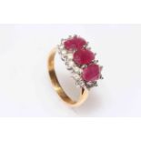 18 carat gold, ruby and diamond ring having three oval rubies bordered with eighteen brilliants,