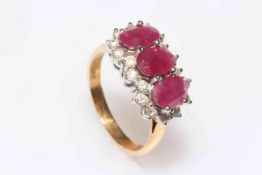 18 carat gold, ruby and diamond ring having three oval rubies bordered with eighteen brilliants,