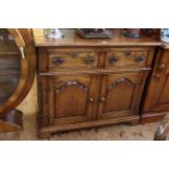 Good quality period style oak dresser having two drawers above two arched fielded panel doors, 91.