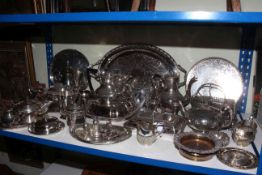 Collection of silver plated wares including ornate teapots, serving trays, tureen, candle holders,