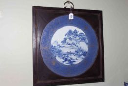 Large framed Chinese blue and white plaque, with figures in river landscape and gilt on blue border,