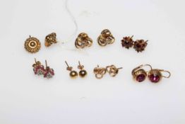 Collection of gold earrings.