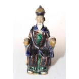 Chinese pottery figure of seated elder, 15cm.