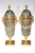 Pair of marble and gilt bronze urns, 32cm high.