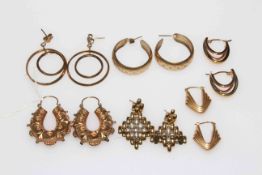 Collection of six pairs of mostly gold earrings.