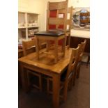 Rectangular oak extending dining table and six ladder back chairs together with a three door