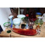 Collection of coloured glass and shades including perfume bottles, Saturn red glass bowl, Alum Bay.