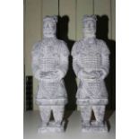 Pair of composite warrior statues, 58cm high.