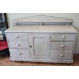 Victorian painted pine dresser having low arched back and central cupboard door flanked by two