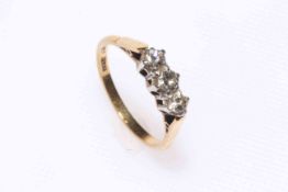 18 carat gold and platinum three stone diamond ring, size P.