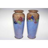 Pair Royal Doulton stoneware vases with foliate band on blue ground, 25cm.