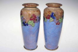 Pair Royal Doulton stoneware vases with foliate band on blue ground, 25cm.