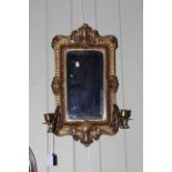 Victorian brass bevelled wall mirror having pair candle scones, 53cm by 29cm.