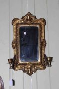Victorian brass bevelled wall mirror having pair candle scones, 53cm by 29cm.