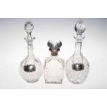 Silver mounted crystal decanter and two further decanters with silver labels.