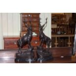 Pair of large impressive bronze models of stags on rocky outcrops raised on marble bases, 47cm high.