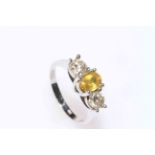 18 carat white gold three stone diamond and citrine ring, size P/Q.