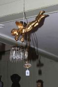 Gilt cherub light fitting, the cherub holding lustre drop fittings.