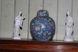 Chinese ginger jar and two white glazed figures.