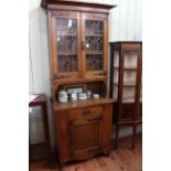 Slim Arts & Crafts oak cabinet bookcase having two leaded glass doors above a tulip inlaid base,