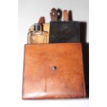 Equestrian leather belt pouch fitted with bottle and double hinged provision box.