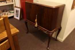 Mahogany two door cocktail cabinet on cabriole legs, 102cm high by 94cm wide by 49cm deep.