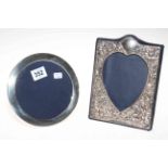 Two silver mounted easel photograph frames, circular and heart shaped.