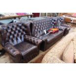 Brown deep buttoned leather three piece wing back Chesterfield suite.