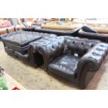 Brown deep buttoned leather two section Chesterfield settee, chair and large footstool.