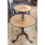 Mahogany two tier graduated circular dumb waiter on pedestal tripod base, 81cm high.