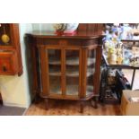 Late Victorian mahogany shaped front vitrine having carved Adams style frieze above pair central