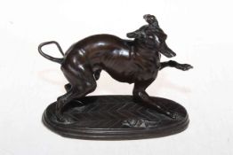 Bronze patinated spelter 'startled hound', 17cm across.