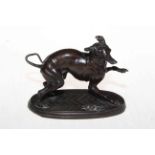 Bronze patinated spelter 'startled hound', 17cm across.