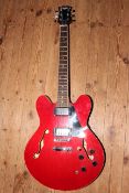 Red Johnny Brook electric guitar with Emax bag.