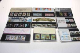 Two shoe boxes of 1980's presentation stamp packs with a face value of approximately £90 including
