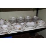 Limoges seventy piece dinner service with two covered tureens and serving dishes.