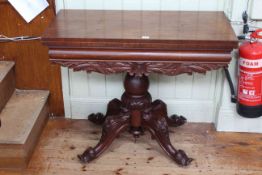 Victorian mahogany fold top tea table on turned pedestal to four scrolled legs,