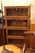 Four height glazed door bookcase and small double door fitted cabinet.