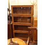 Four height glazed door bookcase and small double door fitted cabinet.