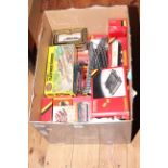 Collection of model railway accessories including rolling stock, track, level crossing,