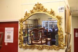 Ornate gilt framed overmantel mirror, 114cm by 120cm.