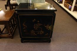 Black lacquered Oriental decorated two door cabinet, 72cm high by 62cm wide by 36cm deep.