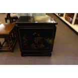 Black lacquered Oriental decorated two door cabinet, 72cm high by 62cm wide by 36cm deep.