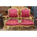 Pair gilt framed open armchairs with serpentine front seats.
