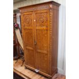 Early 20th Century carved oak double door wardrobe, 202cm high by 113cm wide by 47cm deep.