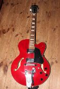 Red Ibanez Artcore electric guitar with Roksak bag.