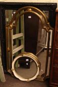 Three various framed wall mirrors.