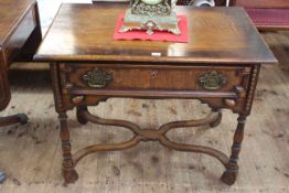 Oak single drawer lowboy raised on four turned legs joined by scrolled stretchers,